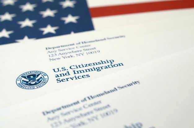 envelopes-with-letter-from-uscis-united-states-flag-from-department-homeland-security_76080-93741